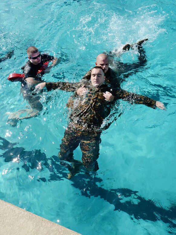 Marines learn how to rescue an unconscious victim during their annual swim qualification at the Base Pool aboard Marine Corps Logistics Base Albany, Aug 24.