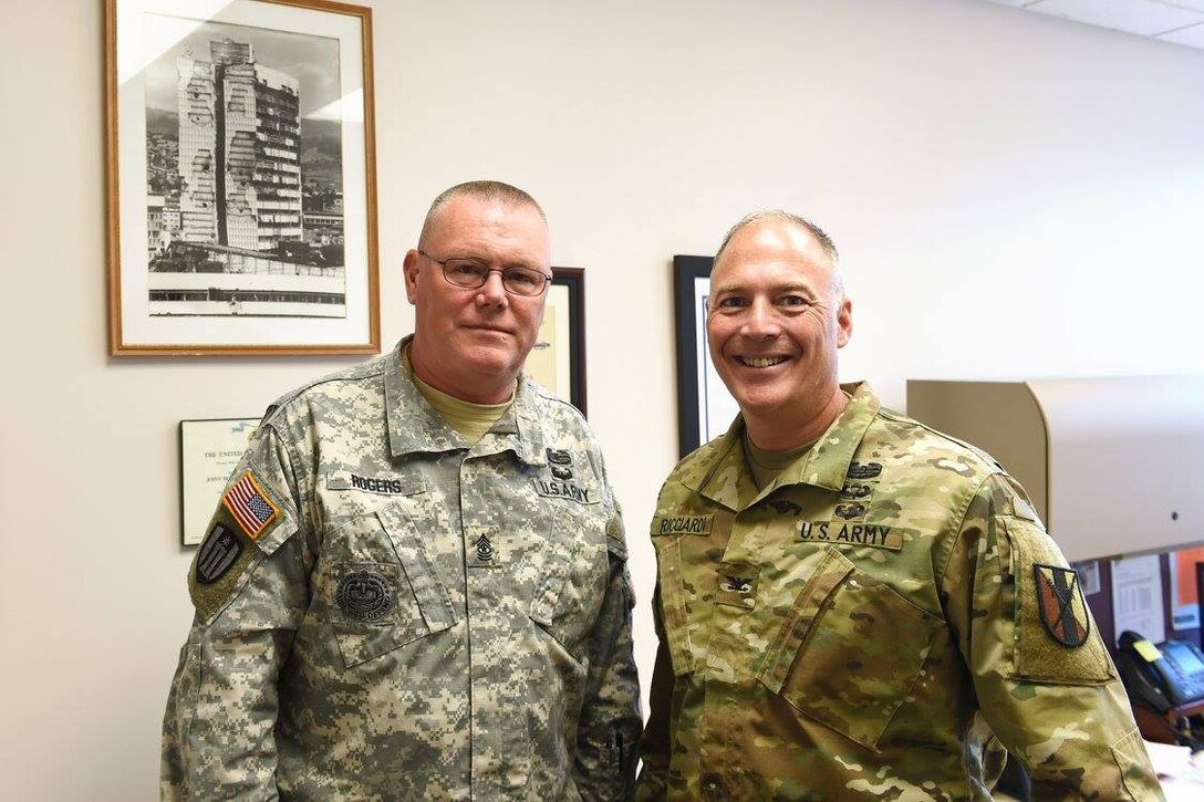 Army Reserve Sgt. Maj. James Rogers, left, and Col. Joseph Ricciardi, Commander, 303d Maneuver Enhancement Brigade (MEB), Honolulu, Hawaii pause for a photo during a visit to the 85th Support Command headquarters. The two served together as a command team for the 863rd Engineer Battalion from 2010-2012. They deployed to Afghanistan from October 2010 to August 2011. 
(Photo by Spc. David Lietz)