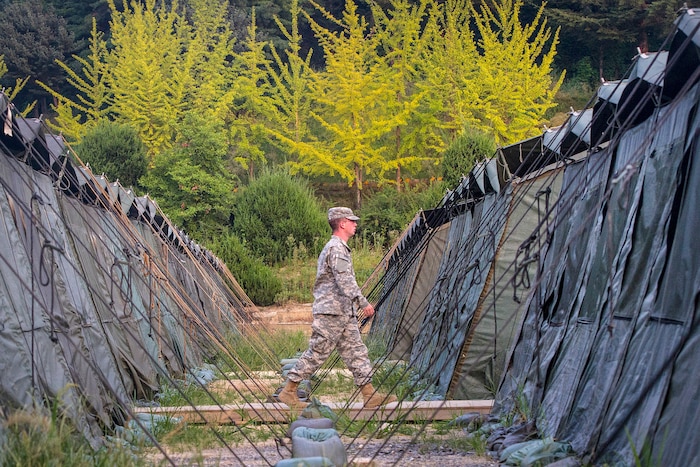A soldier walks between tents during Exercise Ulchi Freedom Guardian 2016 at Yongin, South Korea, Aug 24, 2016. Army photo by Staff Sgt. Ken Scar