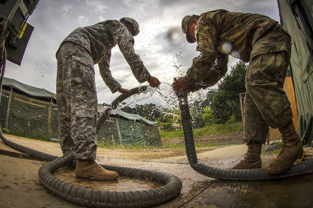 Army Pfc. Andrew Skalecki, right, and Army Spc. Jose Rodriquez resupply the water for over 500 U.S., South Korean and Canadian soldiers participating in Exercise Ulchi Freedom Guardian 2016 at Yongin, South Korea, Aug 25, 2016. Skalecki and Rodriquez are water treatment specialist assigned to the 339th Quartermaster Company. Army photo by Staff Sgt. Ken Scar