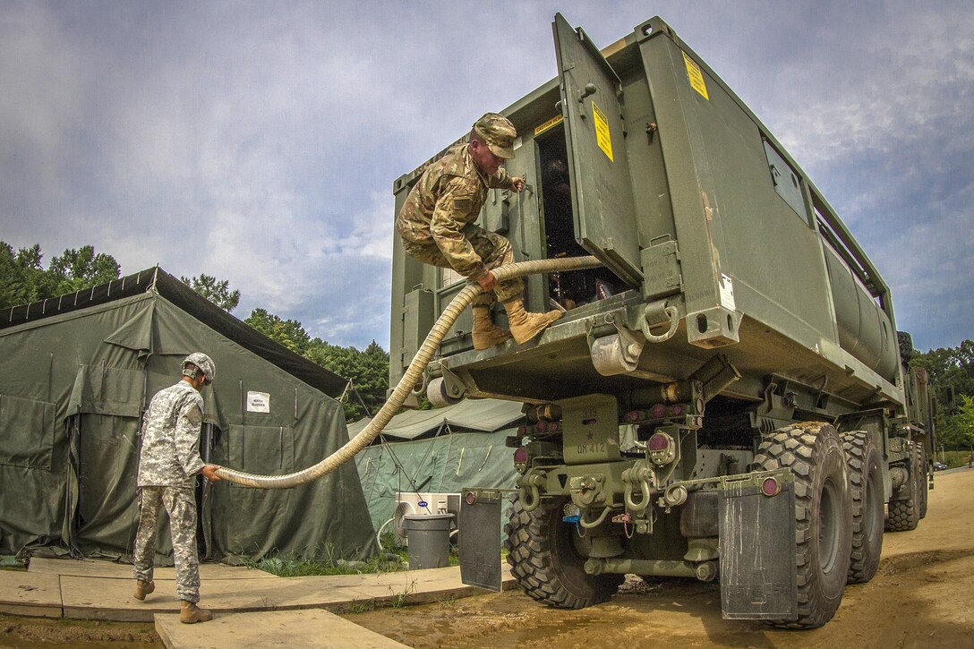 Army Pfc. Andrew Skalecki, right, and Army Spc. Jose Rodriquez resupply the water for over 500 U.S., South Korean and Canadian soldiers participating in Exercise Ulchi Freedom Guardian 2016 at Yongin, South Korea, Aug 25, 2016. Skalecki and Rodriquez are water treatment specialist assigned to the 339th Quartermaster Company. Army photo by Staff Sgt. Ken Scar