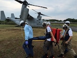 Emergency medical service personnel practice carrying a victim on a stretcher to an MV-22 osprey, assigned to Marine Medium Tiltrotor Squadron (VMM) 262, as part of a disaster drill sponsored by the city of Sasebo, Sep. 01, 2016. The disaster drill is held annually and fosters cooperation between civilian agencies, Japanese self defense forces and  the U.S. military based in Sasebo in the event a disaster were to occur. (U.S. Navy photo by LT. Adam Cole/ Released)