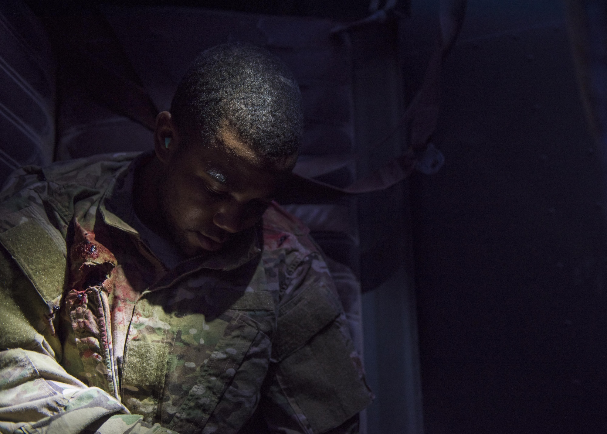 An Airman awaits treatment during a joint integration exercise, Bagram Airfield, Afghanistan, Aug. 31, 2016. Volunteers acted as wounded patients as pararescue specialists performed rescue and recovery efforts. The wounded incurred simulated injuries such as deliria, broken limbs, head and internal injuries. (U.S. Air Force photo by Senior Airman Justyn M. Freeman)