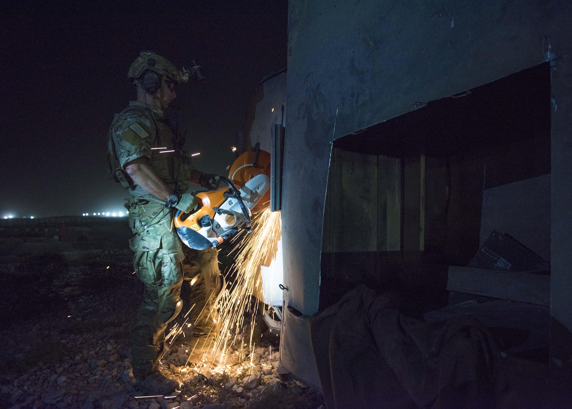 Staff Sgt. Kyle Green, 83rd Expeditionary Rescue Squadron pararescue specialist cuts through the top of a vehicle, Bagram Airfield, Afghanistan, Aug. 31, 2016. The 83rd ERQS worked with Soldiers from the 717th Explosive Ordnance Disposal Unit to identify, remove and dispose of simulated ordnance before rescuing and recovering the injured. (U.S. Air Force photo by Senior Airman Justyn M. Freeman)