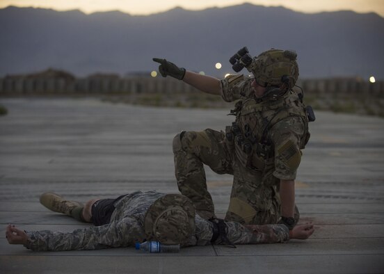 Staff Sgt. Kyle Green, 83rd Expeditionary Rescue Squadron pararescue specialist, signals for assistance while attending to a simulated patient, Bagram Airfield, Afghanistan, Aug. 31, 2016. Pararescue specialists worked to recover simulated wounded patients from scenarios such as being trapped in vehicles and wounds suffered from explosive devices. (U.S. Air Force photo by Senior Airman Justyn M. Freeman)