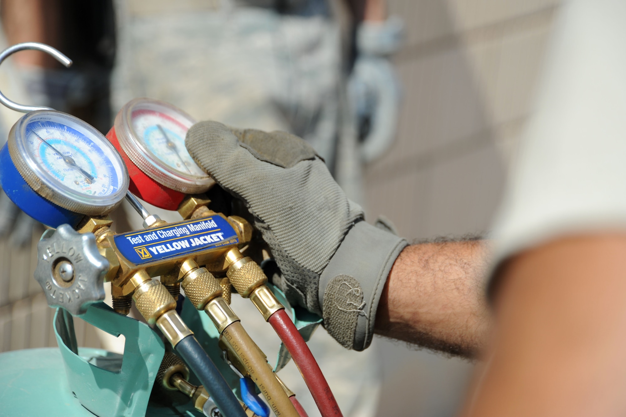 An Airman from the 386th Expeditionary Civil Engineer Squadron heating, ventilation, and air conditioning shop conducts a coolant-level test on an A/C unit Aug. 9, 2016, at an undisclosed location in Southwest Asia. Airmen in the 386 ECES HVAC shop face temperatures reaching the upper 120s every day and do their part to keep the Rock’s mission going. (U.S. Air Force photo/Senior Airman Zachary Kee)