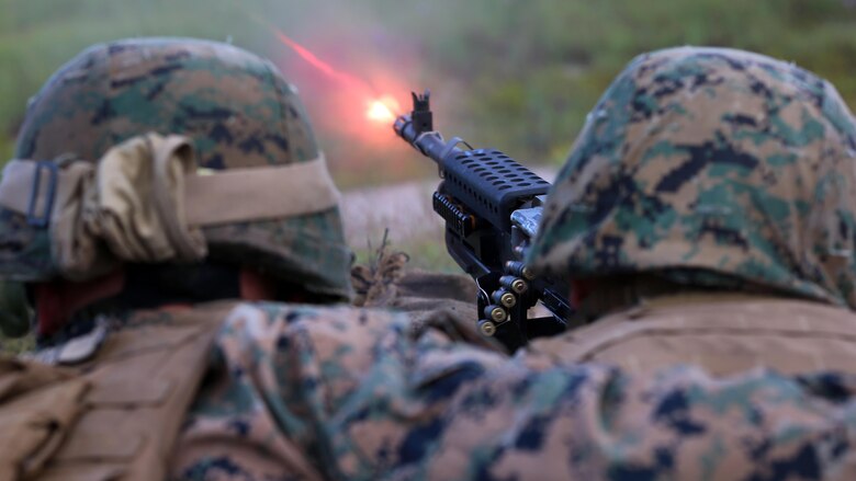 Lance Cpl. Dylan Mclean (left) spots for Cpl. Cody Smith (right) as he fires the M-240 Bravo during a live-fire training exercise conducted by 2nd Low Altitude Air Defense Battalion, Marine Air Control Group 28, 2nd Marine Aircraft Wing at Marine Corps Base Camp Lejeune, N.C., Aug. 29-30. The exercise allowed Marines to re-familiarize themselves and qualify with the M-240 Bravo machine gun, M249 Squad Automatic Weapon, and the M2 Browning .50 caliber machine gun during the unknown distance live-fire exercise. McClean and Smith are gunners with 2nd LAAD, Marine Air Control Group 28, 2nd Marine Aircraft Wing.