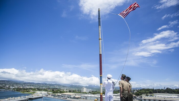 U.S. Marines and Sailors with the 13th Marine Expeditionary Unit and Boxer Amphibious Ready Group moore raise the colors aboard the USS Boxer, Joint Base Pearl Harbor-Hickman Pier, Hawaii, August 29, 2016. The 13th MEU, embarked on the Boxer Amphibious Ready Group, is operating in the U.S. 3rd Fleet area of operations in support of security and stability in the Pacific region.