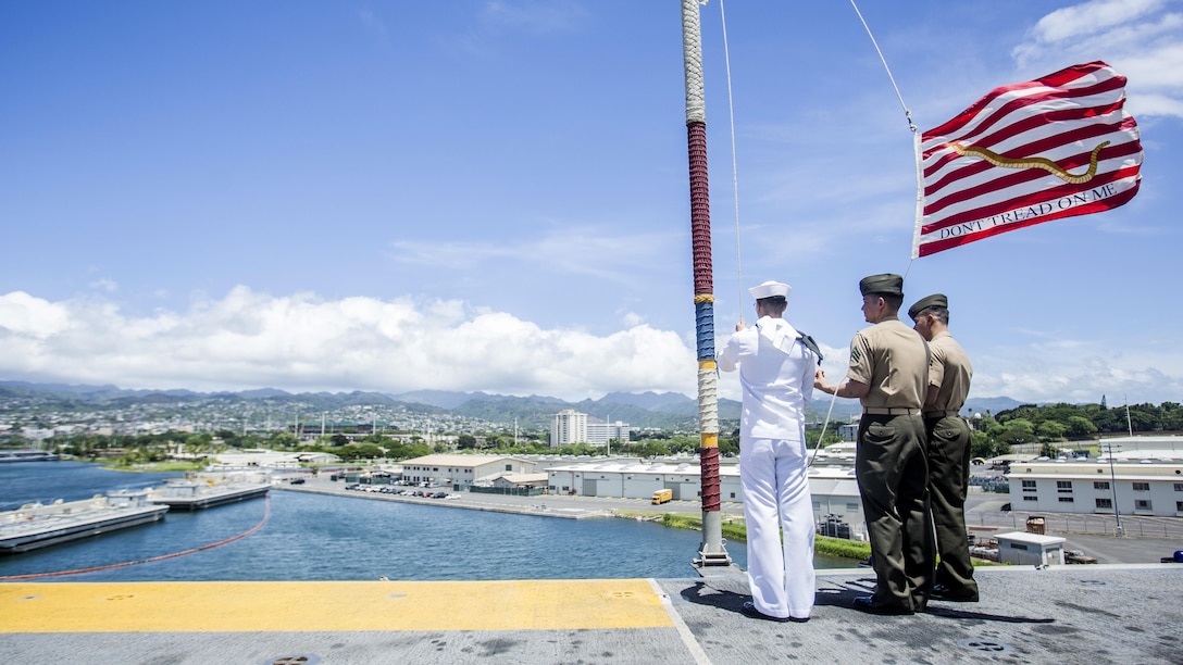 U.S. Marines and Sailors with the 13th Marine Expeditionary Unit and Boxer Amphibious Ready Group moore raise the colors aboard the USS Boxer, Joint Base Pearl Harbor-Hickman Pier, Hawaii, Aug. 29, 2016. The 13th MEU, embarked on the Boxer Amphibious Ready Group, is operating in the U.S. 3rd Fleet area of operations in support of security and stability in the Pacific region.