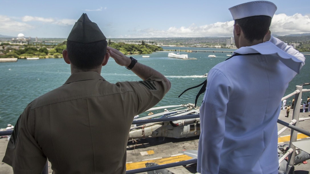 U.S. Marines and Sailors with the 13th Marine Expeditionary Unit and Boxer Amphibious Ready Group salute the USS Arizona memorial while aboard the USS Boxer, Joint Base Pearl Harbor-Hickman Pier, Hawaii, August 29, 2016. The 13th MEU, embarked on the Boxer Amphibious Ready Group, is operating in the U.S. 3rd Fleet area of operations in support of security and stability in the Pacific region.