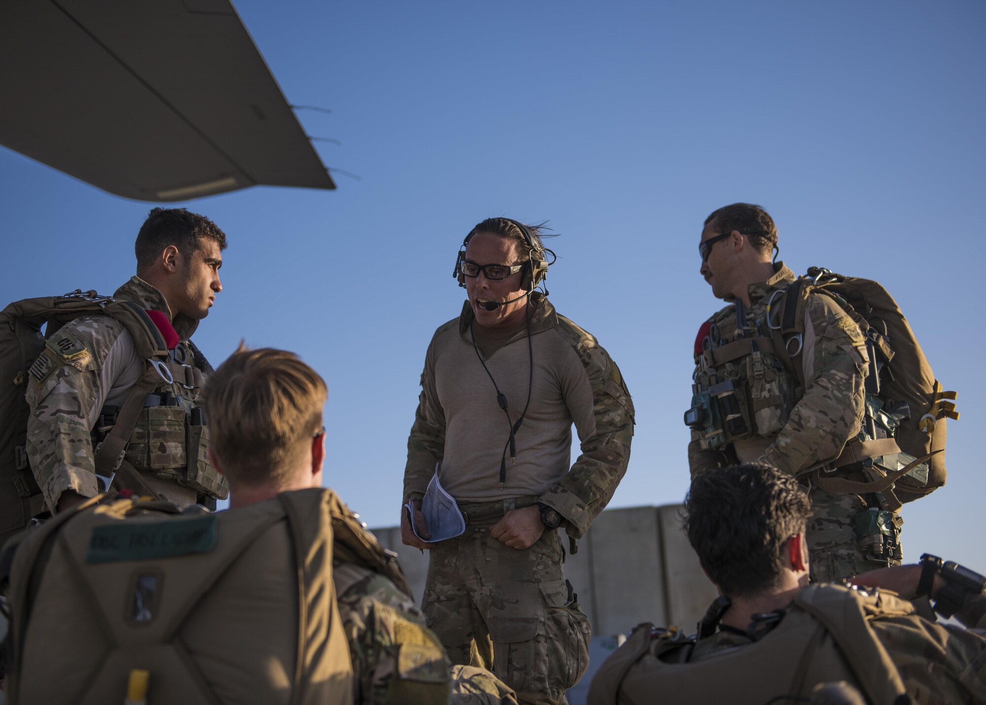 Pararescuemen from the 83rd Expeditionary Rescue Squadron listen to a pre-brief before a jump, Bagram Airfield, Afghanistan, Sept. 03, 2016. Airmen from the 83rd ERQS, 774th Expeditionary Airlift Squadron, and 455th Expeditionary Aeromedical Evacuation Squadron, conducted a first of its kind mission rehearsal. The mission rehearsal integrated the various units to conduct an aerial insertion of an Air Force personnel recovery team. (U.S. Air Force photo by Senior Airman Justyn M. Freeman)