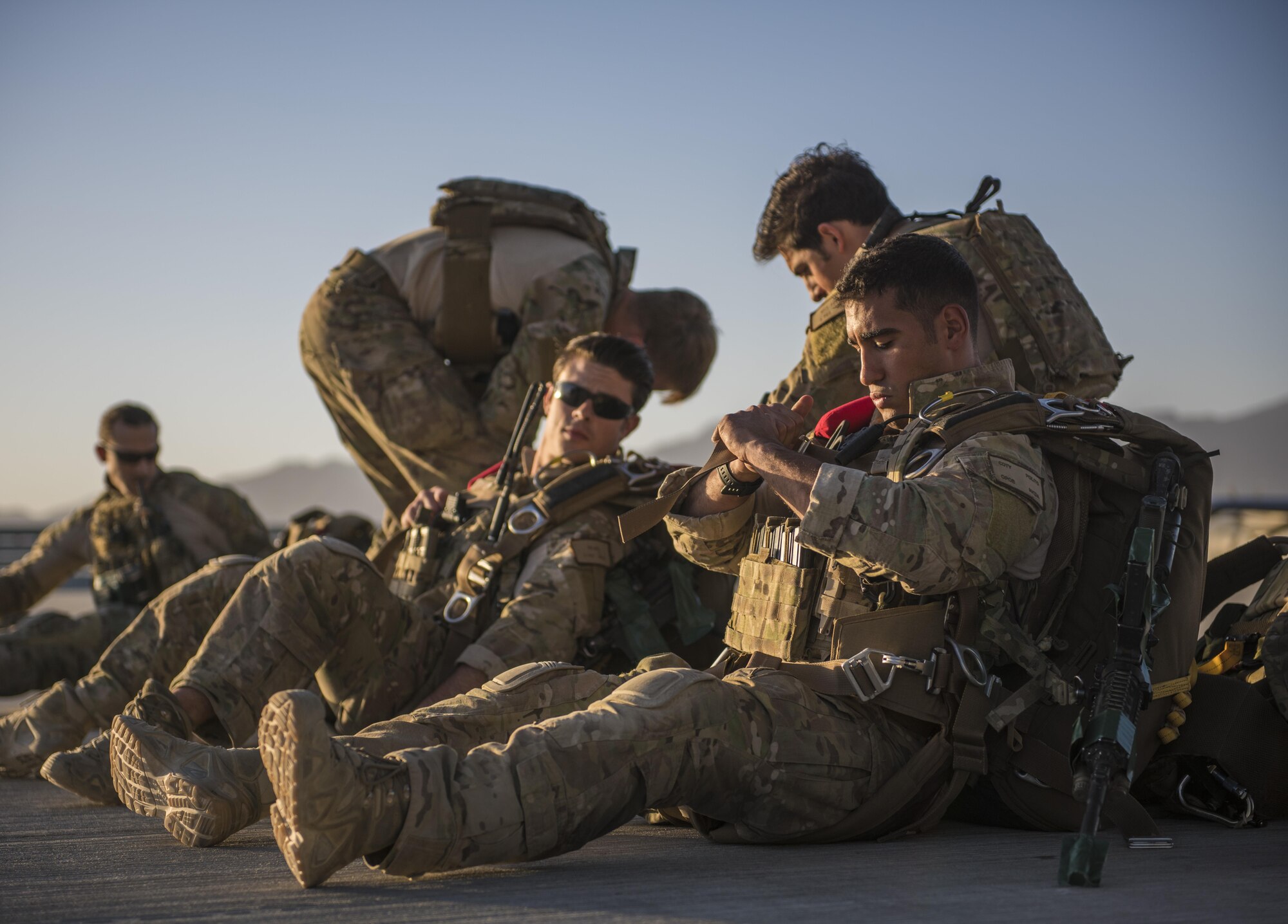 Pararescuemen from the 83rd Expeditionary Rescue Squadron conduct checks before a jump, Bagram Airfield, Afghanistan, Sept. 03, 2016. Airmen from the 83rd ERQS, 774th Expeditionary Airlift Squadron, and 455th Expeditionary Aeromedical Evacuation Squadron, conducted a first of its kind mission rehearsal. The mission rehearsal integrated the various units to conduct an aerial insertion of an Air Force personnel recovery team. (U.S. Air Force photo by Senior Airman Justyn M. Freeman)