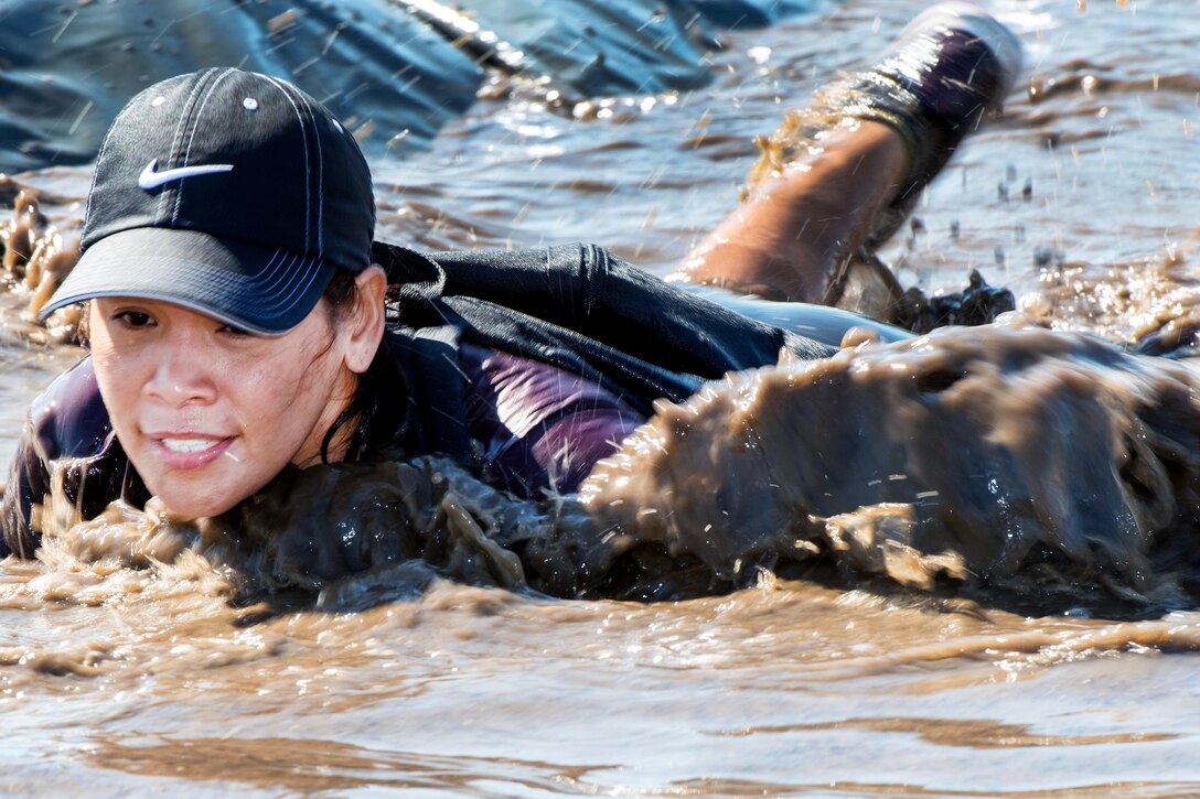 Jenny McMahon, wife of retired Air Force Master Sgt William McMahon, maneuvers through a water obstacle during GoRuch light training at Travis Air Force Base, Calif., Aug. 26, 2016. Air Force photo by Louis Briscese