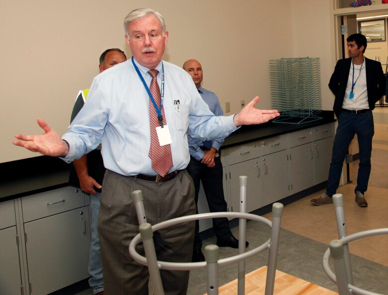 Mr. Lloyd Caldwell, Director of Military Programs tours one of the classrooms at Hanscom Middle School.