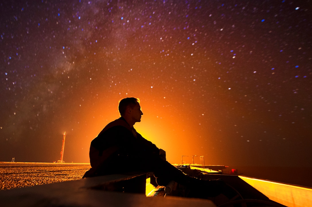 Navy Seaman Theo Shively observes a stellar view from the flight deck aboard the USS Carl Vinson in the Pacific Ocean, Aug. 31, 2016. The aircraft carrier is undergoing a survey and inspection. Navy photo by Seaman Daniel P. Jackson Norgart