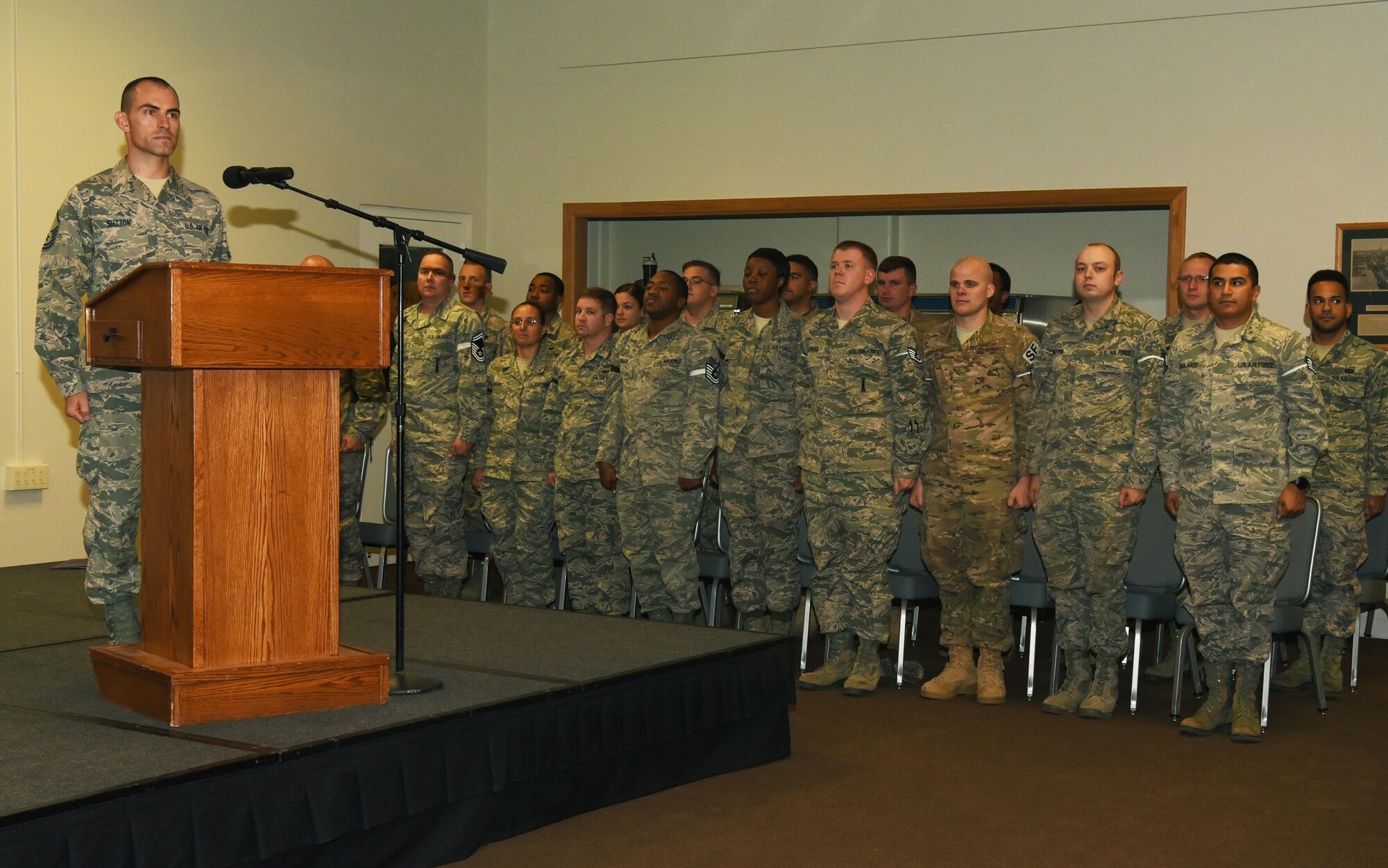 Enlisted Airmen who promoted in August, stand for the national anthem, Aug. 31, 2016, at F.E. Warren Air Force Base, Wyo. Each month the Mighty Ninety hosts a celebration for enlisted promotees from the base. (U.S. Air Force photo by Airman 1st Class Breanna Carter)

