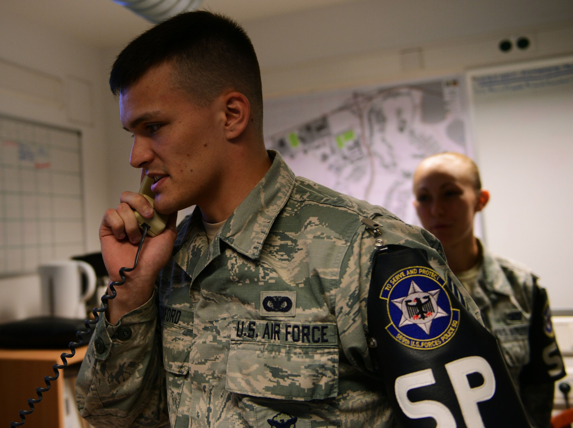 Senior Airman Robert Foxford, 569th U.S. Forces Police Squadron law enforcement desk officer, takes a call Aug. 30, 2016, at Kapuan Air Station, Germany. The 569th USFPS falls under the 86th Mission Support Group, which hosted an immersion tour for Brig. Gen. Richard G. Moore Jr., 86th Airlift Wing commander. (U.S. Air Force photo/Airman 1st Class Joshua Magbanua)