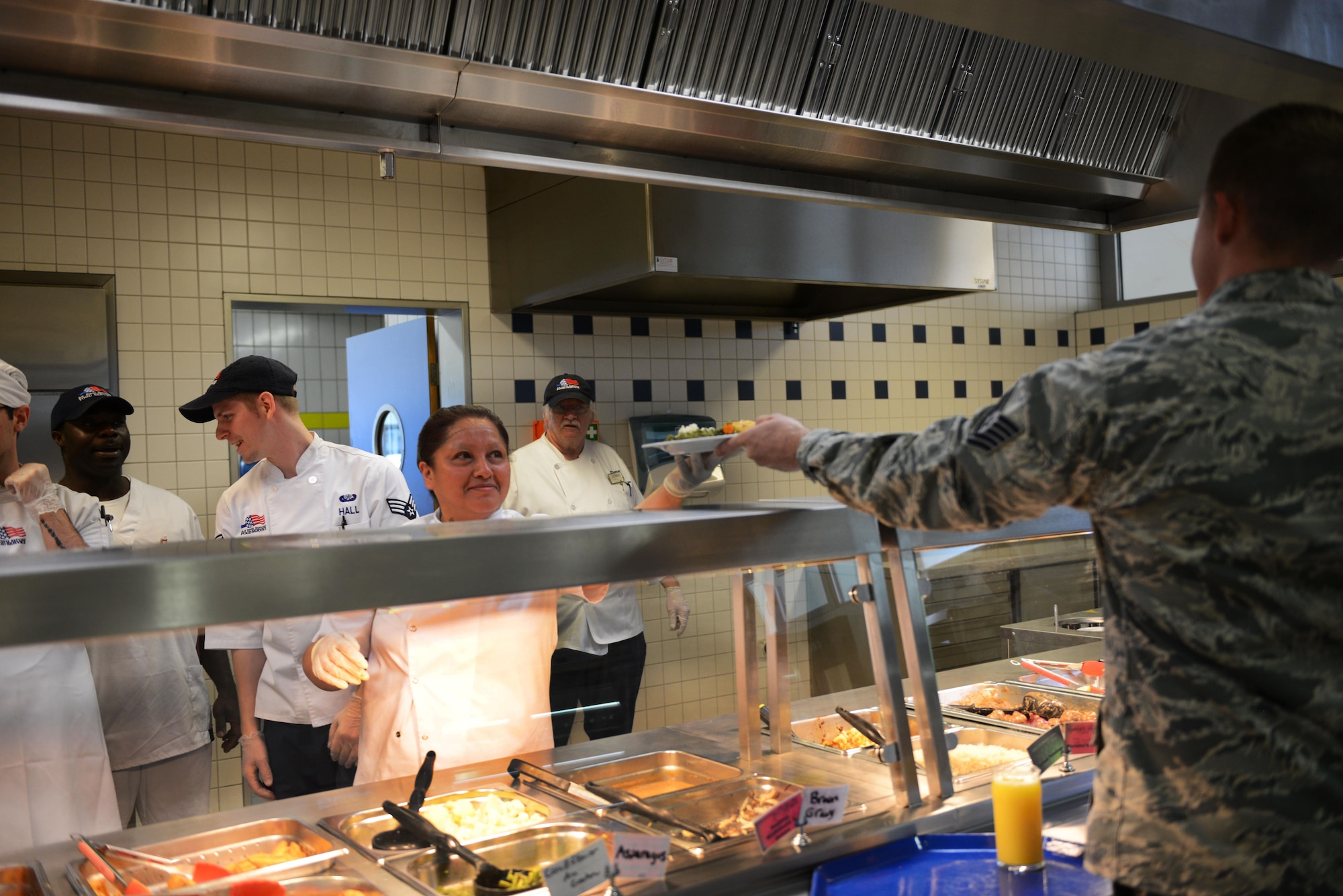 Mabel Raab, 786th Force Support Squadron cook helper, serves an Airman at the Linberg Hof Dining Facility Aug. 30, 2016, at Kapaun Air Station, Germany. The 786th FSS falls under the 86th Mission Support Group, which hosted an immersion tour for Brig. Gen. Richard G. Moore Jr., 86th Airlift Wing commander. (U.S. Air Force photo/Airman 1st Class Joshua Magbanua)