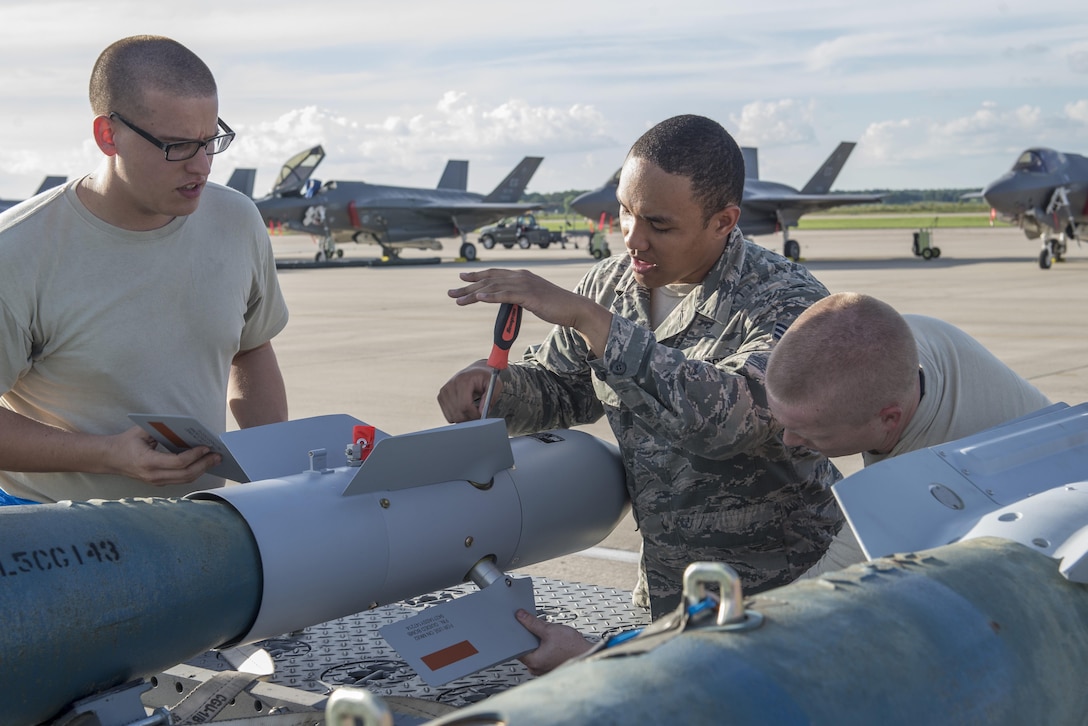 Air Force airmen assemble a Paveway II bomb during Exercise Northern Lightning at Volk Field, Wis., Aug. 30, 2016. The airmen are weapons load crew members assigned to the 58th Aircraft Maintenance Unit. Air Force photo by Senior Airman Stormy Archer