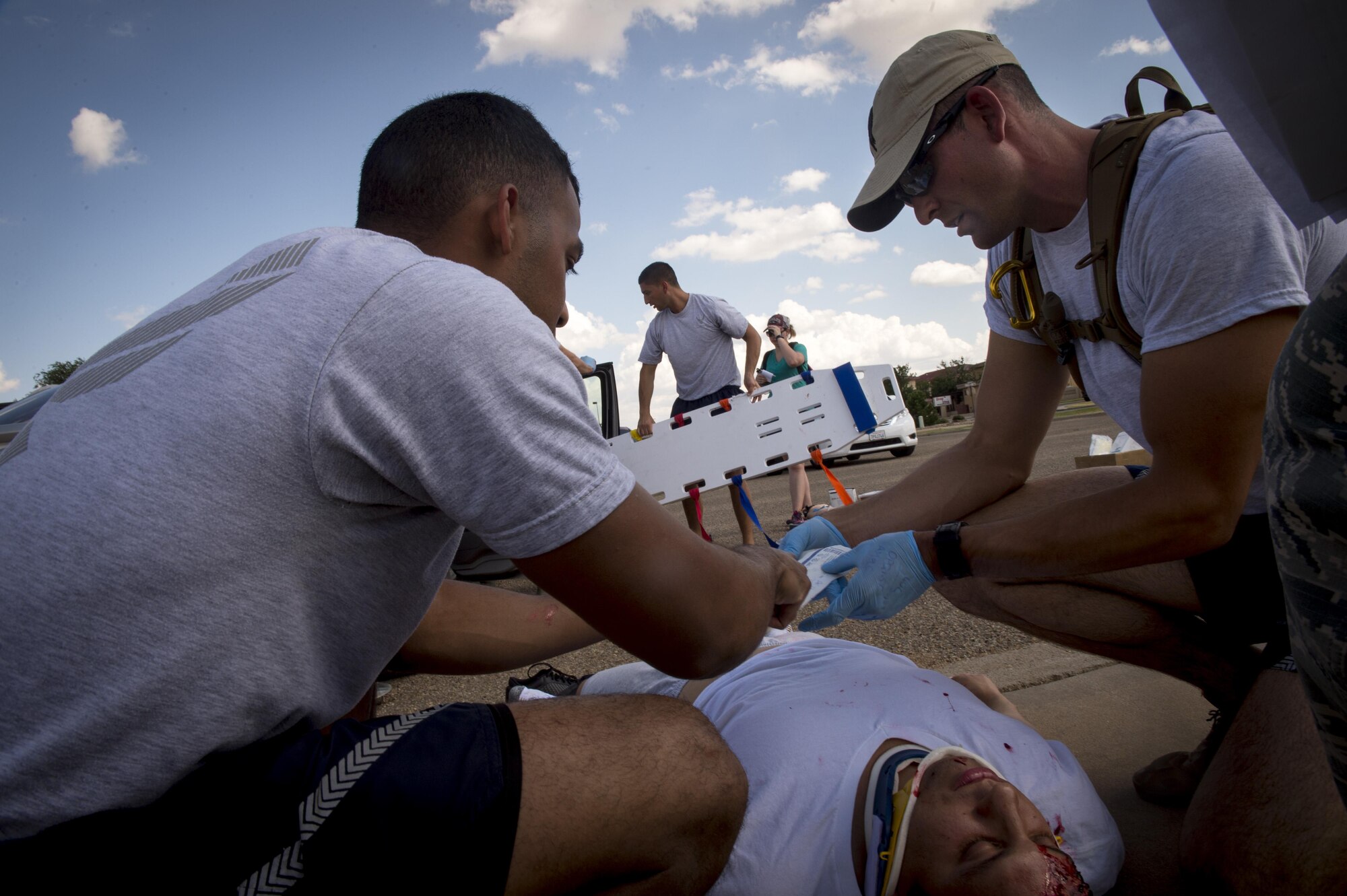 Emergency medical technicians assigned to Malmstrom Air Force Base, Mont., treat a simulated severe care accident victim while teammates try to extract a victim from the car during the 2016 EMT Rodeo Aug. 26, 2016 at Cannon Air Force Base, N.M. Cannon’s EMT Rodeo tests the skills of medical professionals from across the Air Force through a series of innovative, high-pressure scenarios. (U.S. Air Force photo by Tech. Sgt. Manuel J. Martinez)