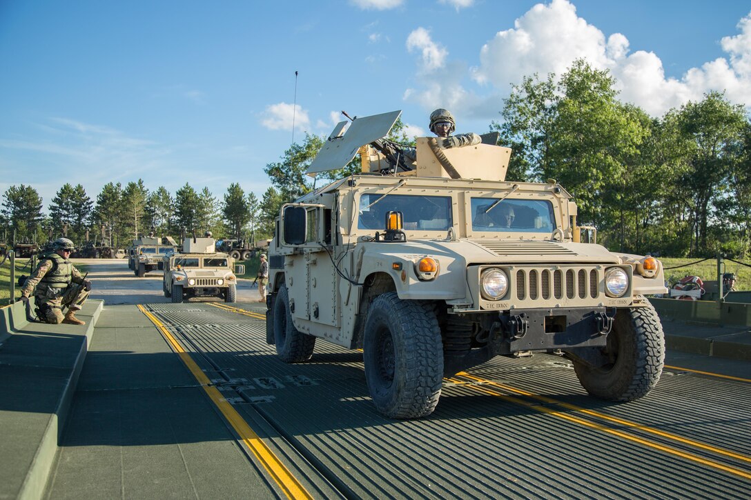 U.S. Army Soldiers from the 805th Military Police Company, Cary, N.C., cross a Ribbon Bridge on Big Sandy lake using High Mobility Multipurpose Wheeled Vehicles (HMMWV) during Combat Support Training Exercise (CSTX) 86-16-03 at Fort McCoy, Wis., August 14, 2016. The 84th Training Command’s third and final Combat Support Training Exercise of the year hosted by the 86th Training Division at Fort McCoy, Wis. is a multi-component and joint endeavor aligned with other reserve component exercises. (U.S. Army photo by Spc John Russell/Released)