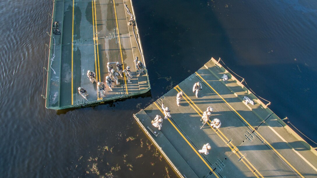 U.S. Army Soldiers of the 652nd Engineer Company, Ellsworth, Wis., and the 739th Engineer Company, Granite City, Ill., construct a Ribbon Bridge on Big Sandy Lake during Combat Support Training Exercise (CSTX) 86-16-03 at Fort McCoy, Wis., August 14, 2016. The 84th Training Command’s third and final Combat Support Training Exercise of the year hosted by the 86th Training Division at Fort McCoy, Wis. is a multi-component and joint endeavor aligned with other reserve component exercises. (U.S. Army photo by Spc John Russell/Released)