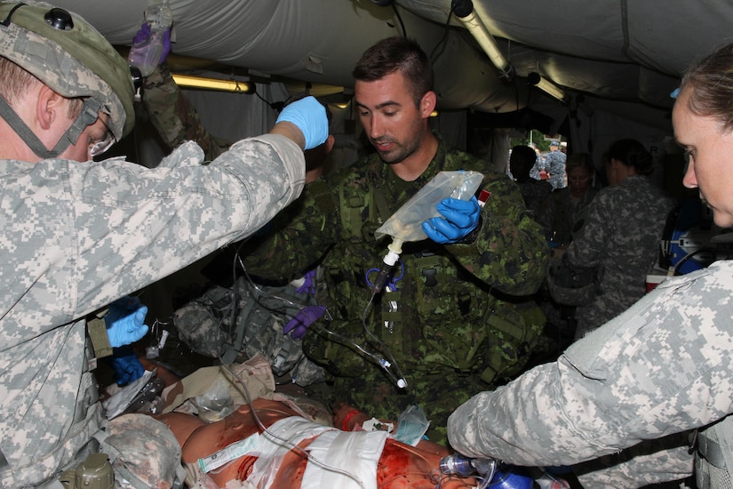 FORT MCCOY, Wis. - Canadian Cpl. James Sinclair, medic, 31 Canadian Forces Health Service, works alongside U.S. Army Reserve Soldiers Aug. 20 during Combat Support Training Exercise 86-16-03 at Fort McCoy, Wis. (U.S. Army Reserve photo by Staff Sgt. Debralee Best)