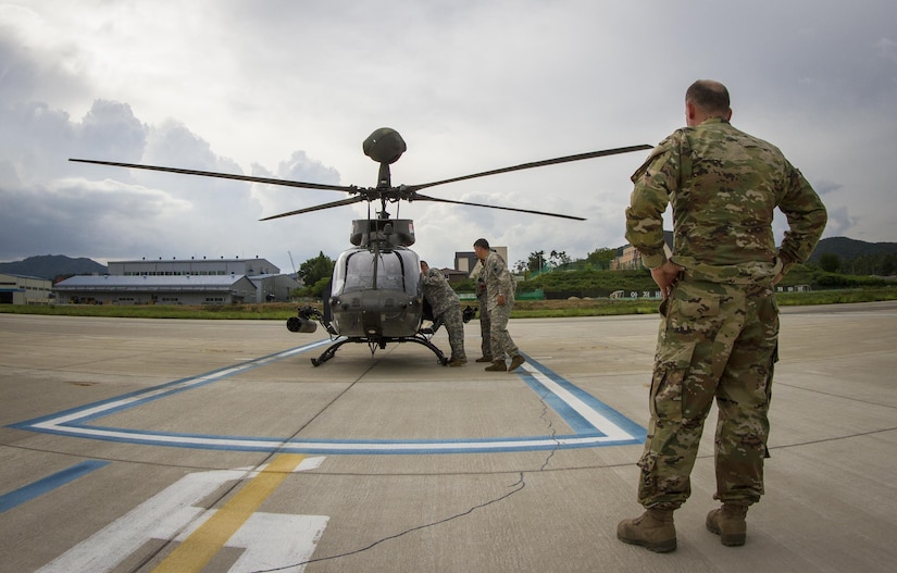 U.S. Army Col. Michael Harvey, I Corps executive officer to the commanding general, watches an OH-58D Kiowa Warrior crew prepare for takeoff from an airfield in Yongin, South Korea, Aug. 29, 2016. The helicopter belonged to the 1st Squadron, 17th Cavalry Regiment, the last squadron of OH-58's. Once their deployment is over the Army will retire all OH-58's from its fleet. Harvey logged more than 1,900 hours flying the aircraft during his Army career. (U.S. Army photo by Staff Sgt. Ken Scar)