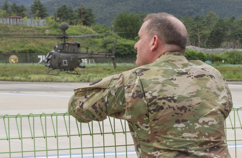 U.S. Army Col. Michael Harvey, executive officer to the commanding general of I Corps, watches an OH-58D Kiowa Warrior take off from an airfield in Yongin, South Korea, Aug. 29, 2016. The helicopter belonged to the 1st Squadron, 17th Cavalry Regiment, the last squadron of OH-58's. Once their deployment is over the Army will permanently retire them. Harvey has logged more than 1,900 hours flying the aircraft during his Army career. (U.S. Army photo by Staff Sgt. Ken Scar)