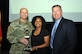 Radiah Scott represents trophy recipient Michael Brown of U.S. Army Center for Initial Military Training, who received the most hourly fitness points with a total of 200.75 during the six-month Fort Eustis Civilian Fitness Commander’s Cup Challenge, at an awards ceremony at Fort Eustis, Va., Aug. 31, 2016.  She is joined by Senior Commander, Maj. Gen. Anthony C. Funkhouser and U.S. Army Training and Doctrine Command G-1/4 Assistant Deputy Chief of Staff Hugh Davis. (U.S. Army photo by Stephanie Slater)