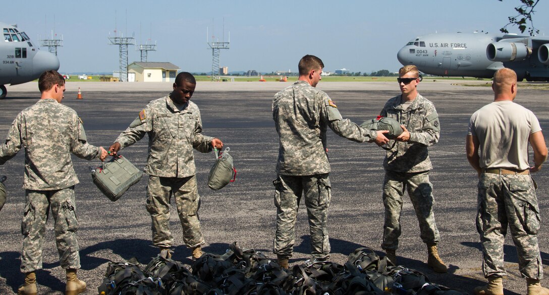 Soldiers of the 861st Quartermaster Company unload parachutes at the airfield in Nashville on Saturday, Aug. 27, in preparation for a jump latrer in the day at Fort Campbell, Kentucky.