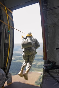 A Soldier from the 861st Quartermaster Company jumps out of a C-130 to Corregidor Drop Zone at Fort Campbell, Kentucky, on Saturday, Aug. 27.