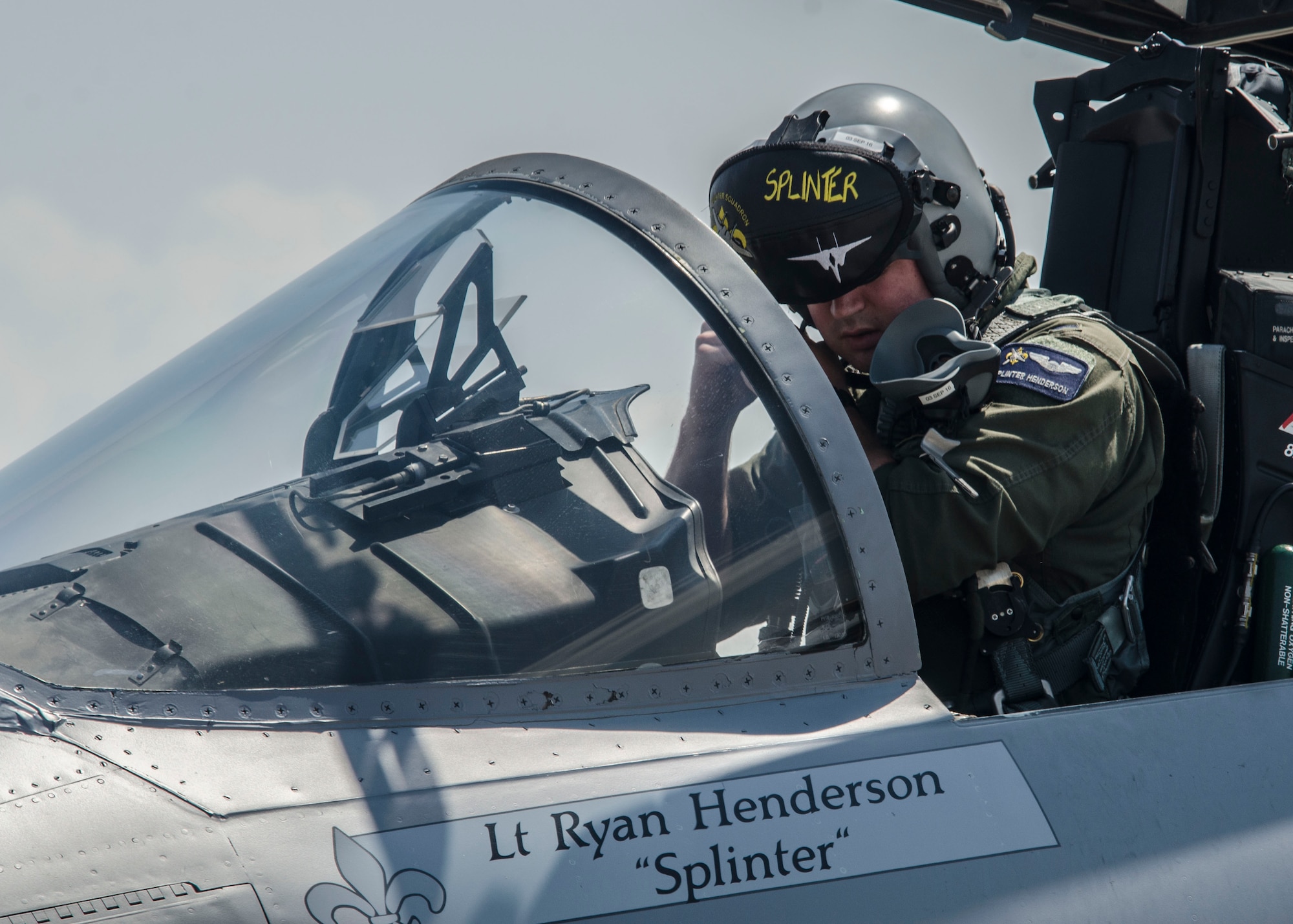 U.S. Air Force 1st Lt. Ryan Henderson, 122nd Fighter Squadron, assigned to the 159th Fighter Wing, Louisiana Air National Guard, puts on his helmet in an F-15C Eagle at Nellis Air Force Base, Nev., Aug. 24, 2016. The 122nd FS played a key role during exercise Red Flag 16-4 by providing air-to-air support for friendly forces during Red Flag 16-4. (U. S. Air Force photo by Tech. Sgt. Frank Miller)