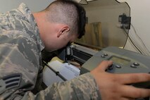 Senior Airman Michael Muldoon, a structural journeyman assigned to the 5th Civil Engineer Squadron, aligns a blade to a cross hair at Minot Air Force Base, N.D., Aug. 10, 2016. Once the cross hair is aligned, the plotter knows where to properly cut the new sign. (U.S. Air Force photo/Airman 1st Class Jessica Weissman)