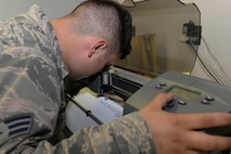 Senior Airman Michael Muldoon, a structural journeyman assigned to the 5th Civil Engineer Squadron, aligns a blade to a cross hair at Minot Air Force Base, N.D., Aug. 10, 2016. Once the cross hair is aligned, the plotter knows where to properly cut the new sign. (U.S. Air Force photo/Airman 1st Class Jessica Weissman)