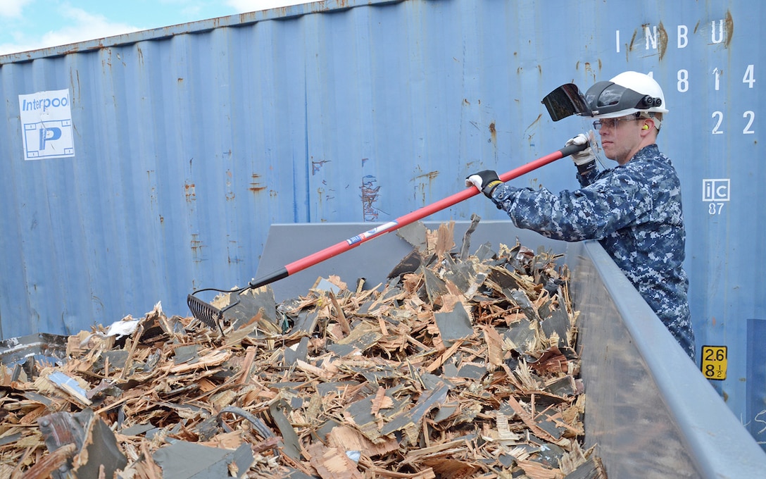 Navy Petty Officer 2nd Class Jeff Leet combs through a bin of scrap material during pre-deployment training in Battle Creek, Michigan.