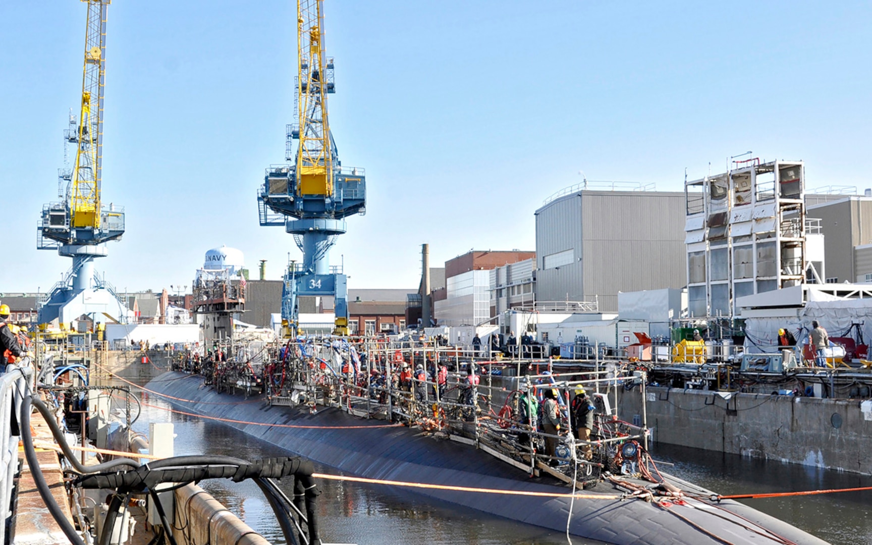 Workers from the Portsmouth Naval Shipyard in Maine swarm over the deck of USS Scranton  during an engineered overhaul in 2014.— 