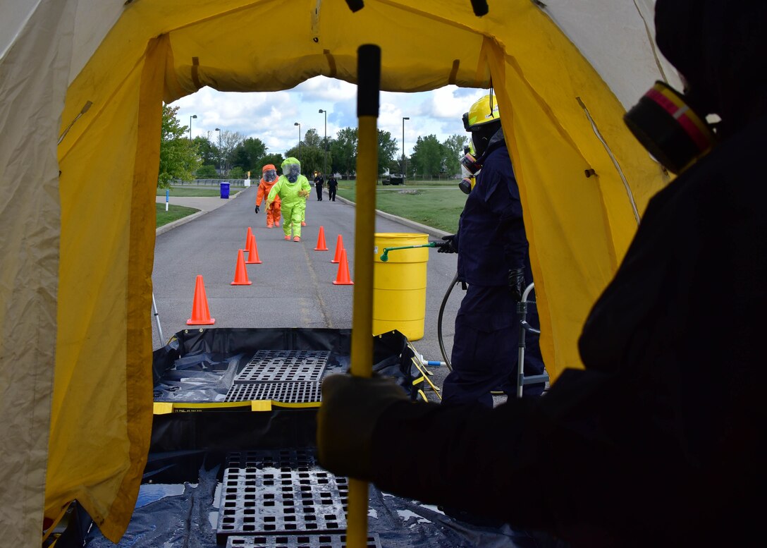 Members of the 914th Airlift Wing Fire Department prepare to enter a decontamination station as part of an exercise on Thursday, September 1, 2016. The exercise showcased interoperability of base and local first responder units in a simulated bomb attack. (U.S. Air Force photo by Staff Sgt. Richard Mekkri/released)
