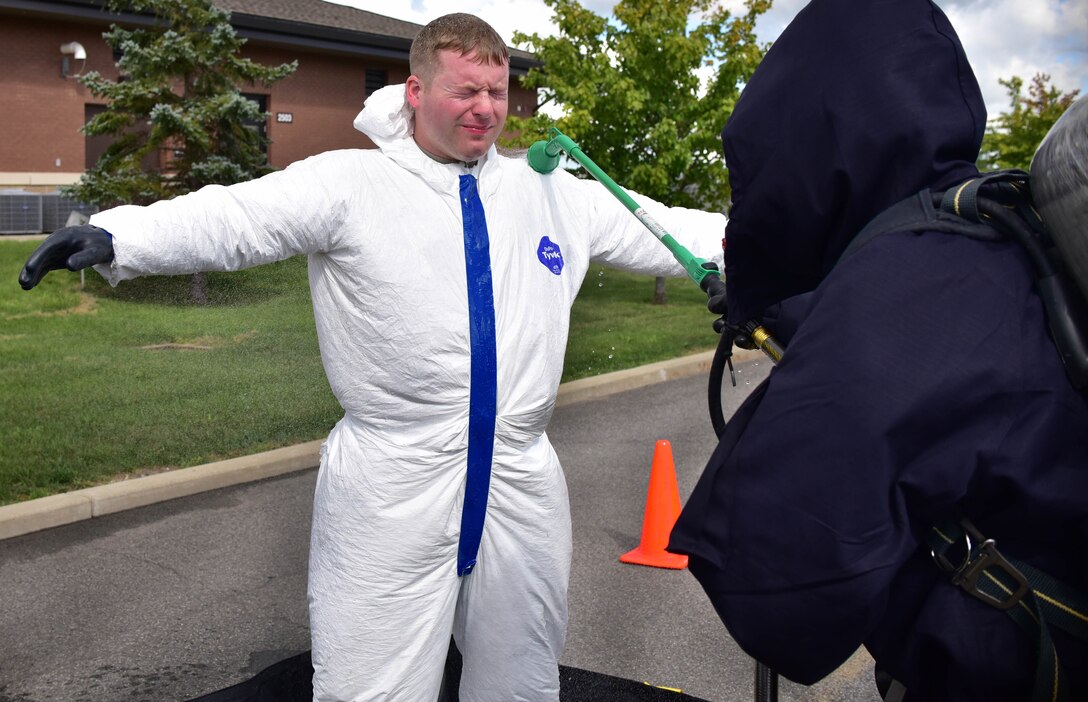 Staff Sgt. Joseph Kulczyk begins the decontamination process during a drill on Thursday, September 1, 2016. The drill was a simulation involving multiple agencies showcasing interoperability on base in case a radioactive incident were to take place. (U.S. Air Force photo by Staff Sgt. Richard Mekkri/released)