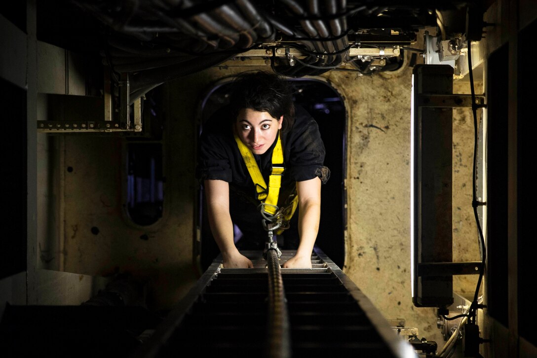 Navy Seaman Krystal Paquette climbs down the interior of the mast of the aircraft carrier USS Dwight D. Eisenhower in the Persian Gulf, Sept. 2, 2016. The Eisenhower is supporting Operation Inherent Resolve, maritime security operations and theater security cooperation efforts in the U.S. 5th Fleet area of operations. Navy photo by Petty Officer 3rd Nathan T. Beard
