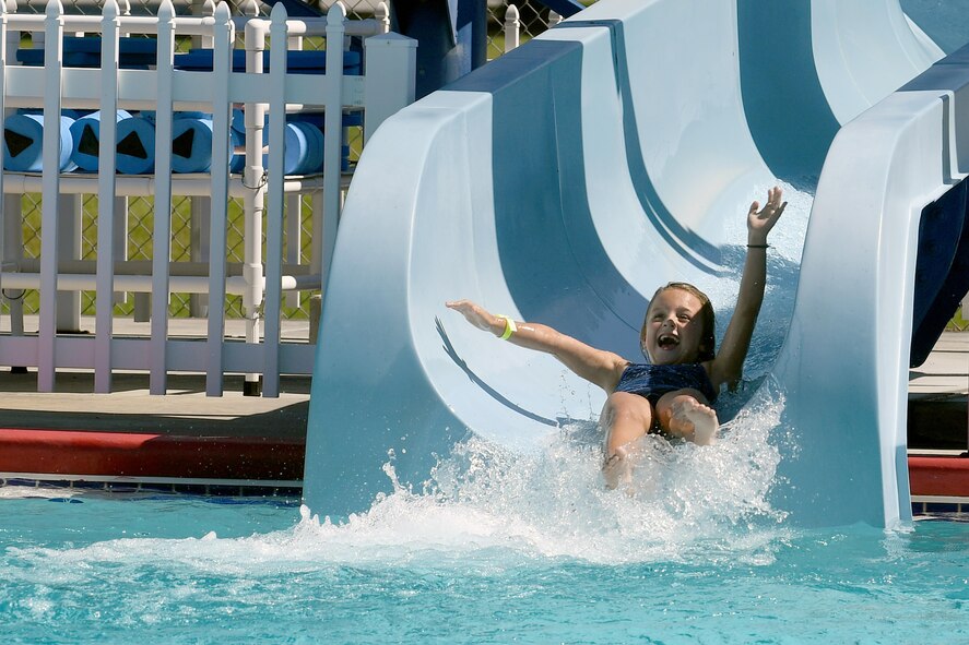 Avery Stidham, daughter of U.S. Air Force Staff Sgt. Jared Stidham, 38th Rescue Squadron, splashes into the water at the bottom of a water slide during the Labor Day “Splash Party,” Sept. 5, 2016, at Moody Air Force Base, Ga. Airmen and their families were able to enjoy the free event that included poolside games, music, free popsicles and door prizes. (U.S. Air Force photo by Staff Sgt. Brian J. Valencia)