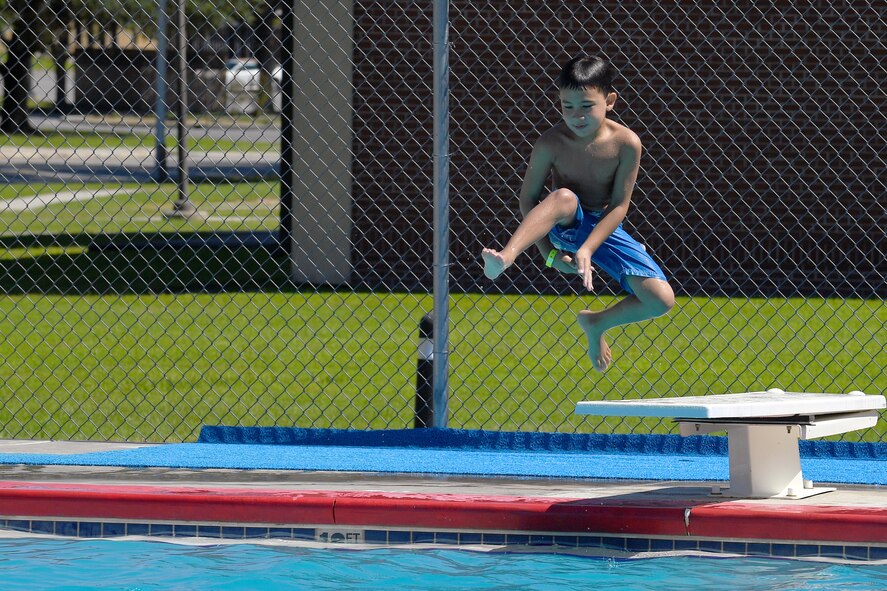 Gabriel Morris, son of U.S. Air Force Tech. Sgt. Annabel Morris, 476th Fighter Group, leaps from a diving board during the Labor Day “Splash Party,” Sept. 5, 2016, at Moody Air Force Base, Ga. All children must pass a swim test before they can use the diving board or swim in sections deeper than four feet. (U.S. Air Force photo by Staff Sgt. Brian J. Valencia)