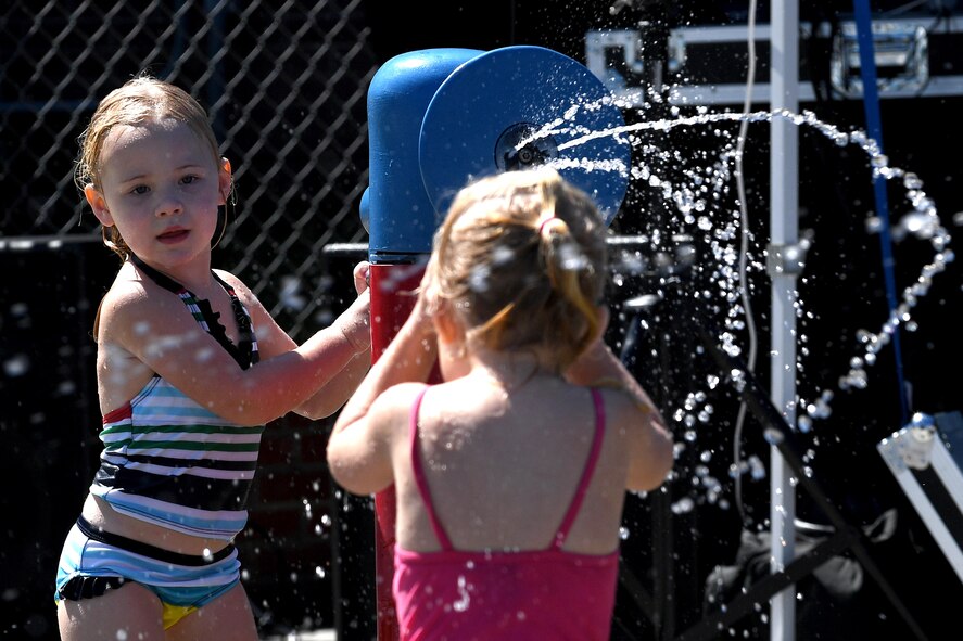 Autumn Hughes uses a sprinkler canon to spray water at unsuspecting children during the Labor Day “Splash Party,” Sept. 5, 2016, at Moody Air Force Base, Ga. In addition to the pool and water slide, the outdoor pool has a section featuring a variety of sprinkler systems for children to enjoy. (U.S. Air Force photo by Staff Sgt. Brian J. Valencia)