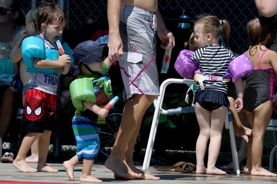 Children take a break from playing in the water to enjoy a free popsicle during the Labor Day “Splash Party,” Sept. 5, 2016, at Moody Air Force Base, Ga. The event offered free popsicles to everyone who attended as well as live music and door prizes. (U.S. Air Force photo by Staff Sgt. Brian J. Valencia)
