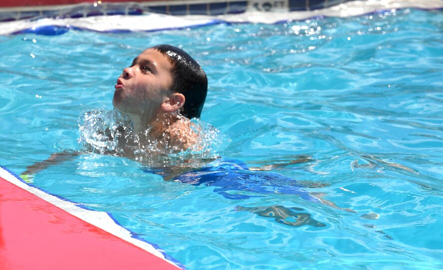 Gabriel Morris, son of U.S. Air Force Tech Sgt. Annabel Morris, 476th Fighter Group, emerges from the water at the outdoor pool during the Labor Day “Splash Party,” Sept. 5, 2016, at Moody Air Force Base, Ga. Airmen and their families enjoyed a day in the sun as they celebrated Labor Day with a break from work. (U.S. Air Force photo by Staff Sgt. Brian J. Valencia)