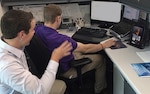 John Slone (left) and Jon Mowl of DLA Finance use the virtual remote interpreting service via tablet. The service is being tested at DLA Headquarters as a tool to improve communication for deaf employees. 