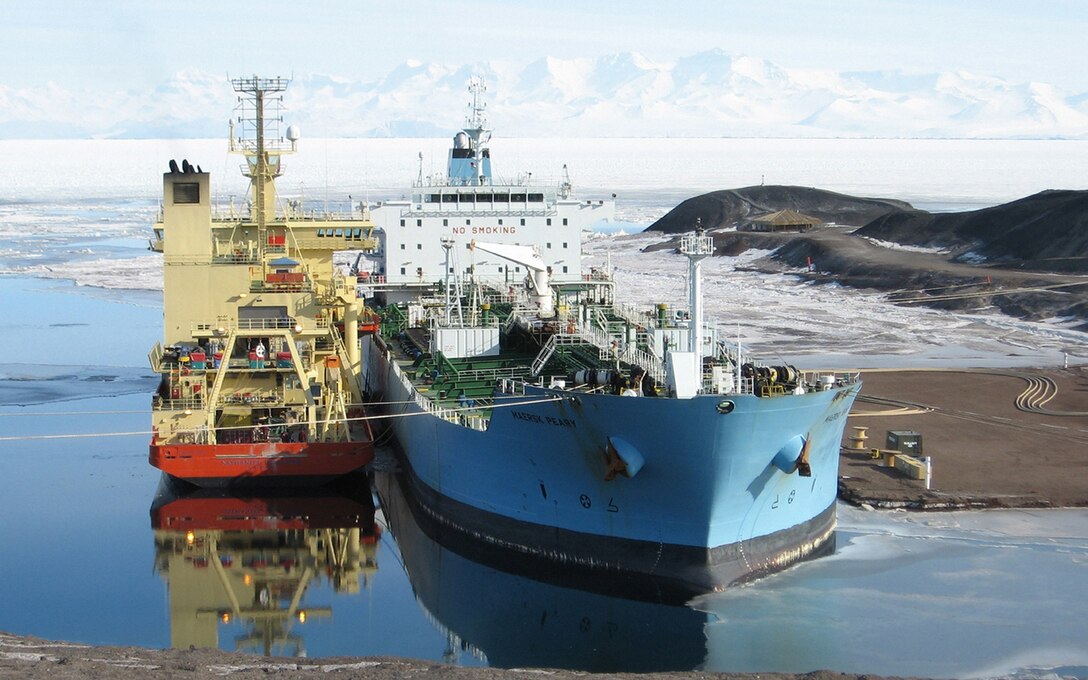 The Military Sealift Command-chartered tanker ship MV Maersk Peary provides DLA Energy-procured fuel to the National Science Foundation-chartered scientific research vessel R/V Nathanial B. Palmer at McMurdo Station ice pier. 