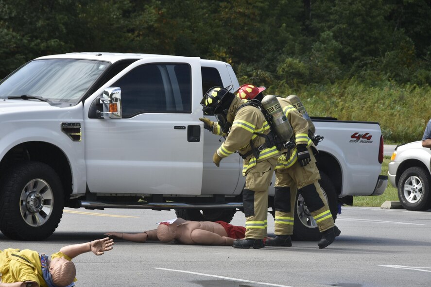 AEDC Fire-Rescue personnel examine training mannequins that represent injured persons during the emergency simulation.