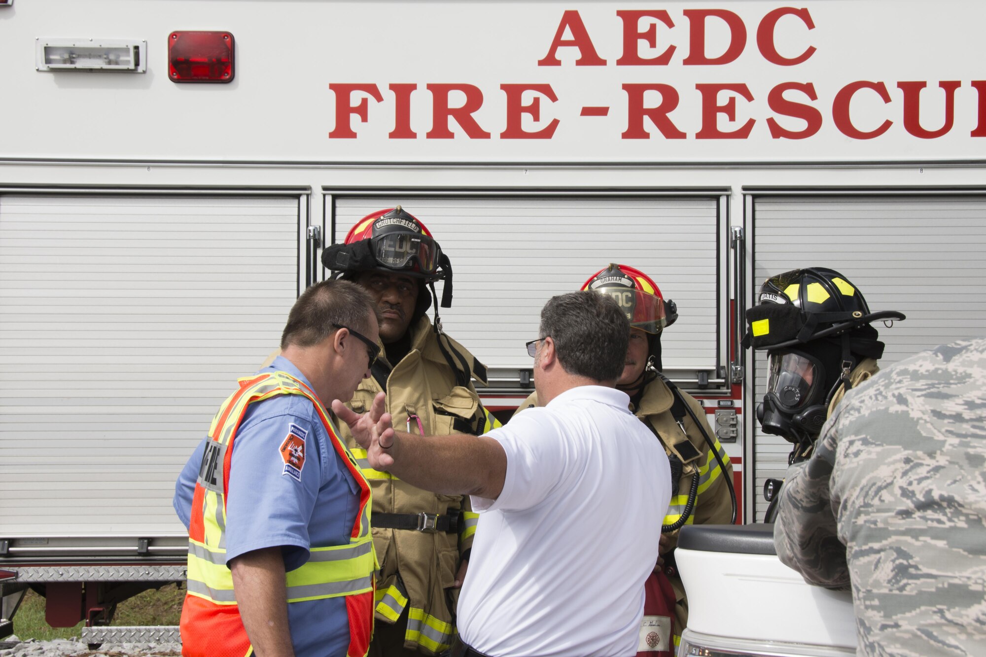 AEDC Fire-Rescue team members discuss emergency exercise details.
