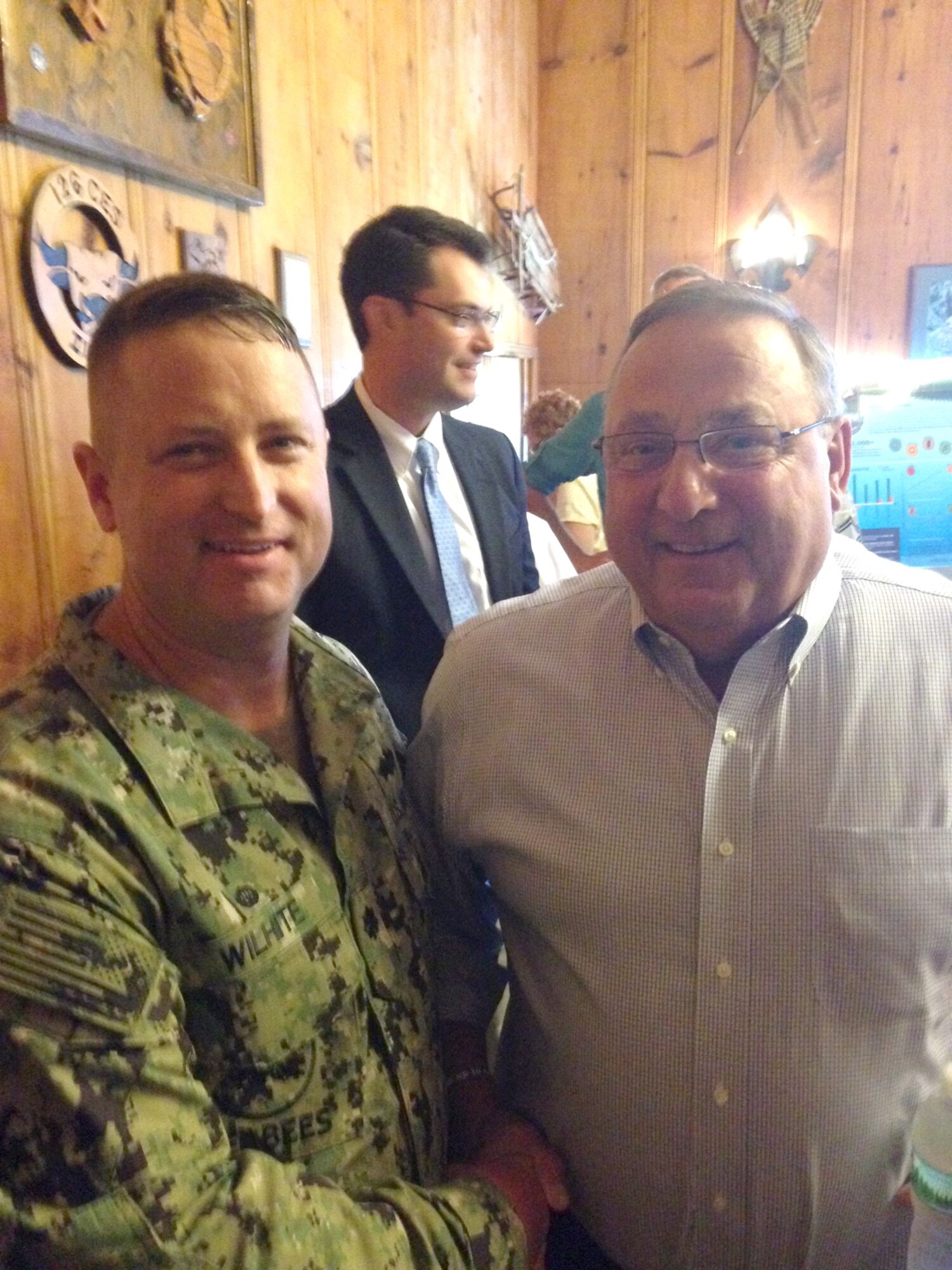 Cmdr. David Wilhite, left, of the U.S. Navy Reserve, Commander of the Naval Mobile Construction Battalion 14, presents a Command Coin to Maine Gov. Paul LePage, right, during a Distinguished Visitor Day at Camp William Hinds in Maine. The event was held in support of a Joint Innovative Readiness Training (IRT) Project at the camp. In addition to his duties as commander of NMCB 14, Wilhite also serves as the Simplified Acquisition of Base Engineering Requirements program manager at AEDC. (Courtesy photo/David Wilhite)